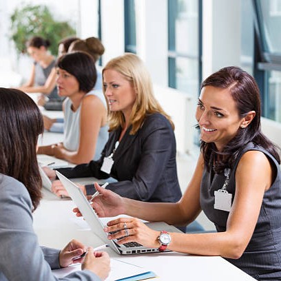 Group of women attending a job fair, working together and discussing.